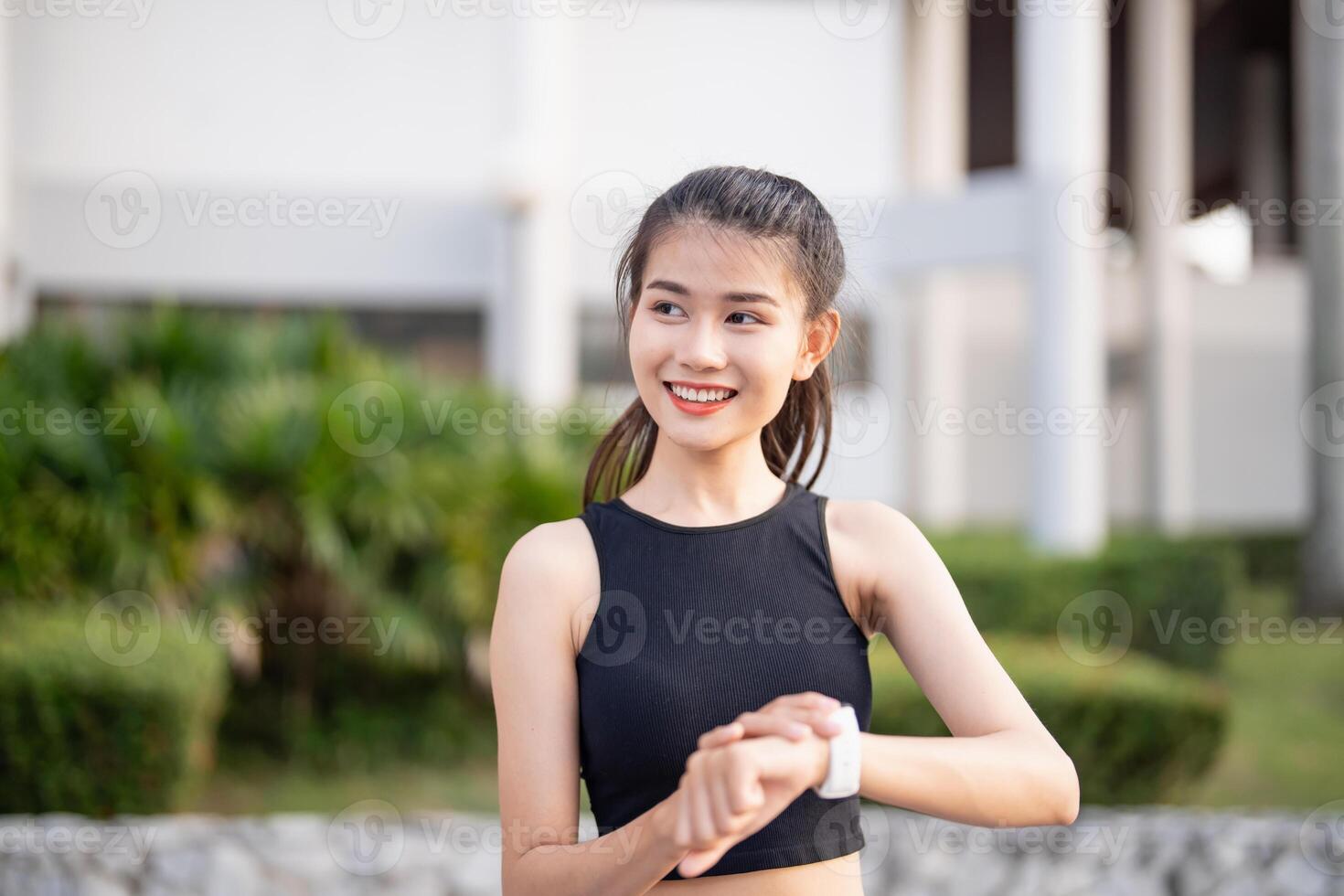 asian sporty woman wearing black sports bra and black shorts photo