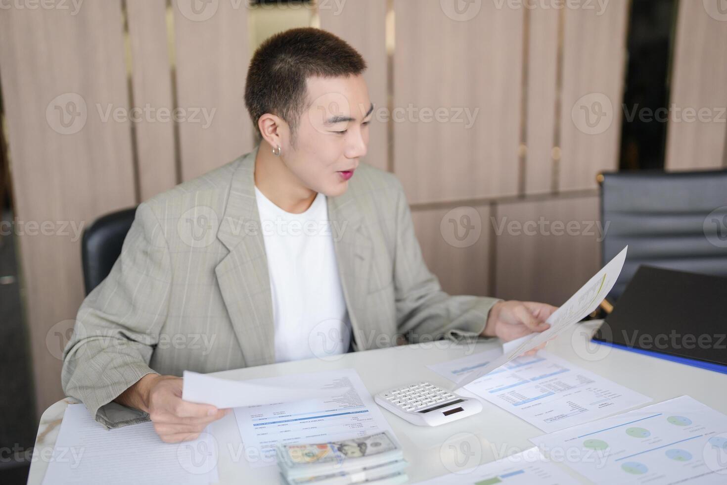 a Confident man in a suit is looking at paperwork photo