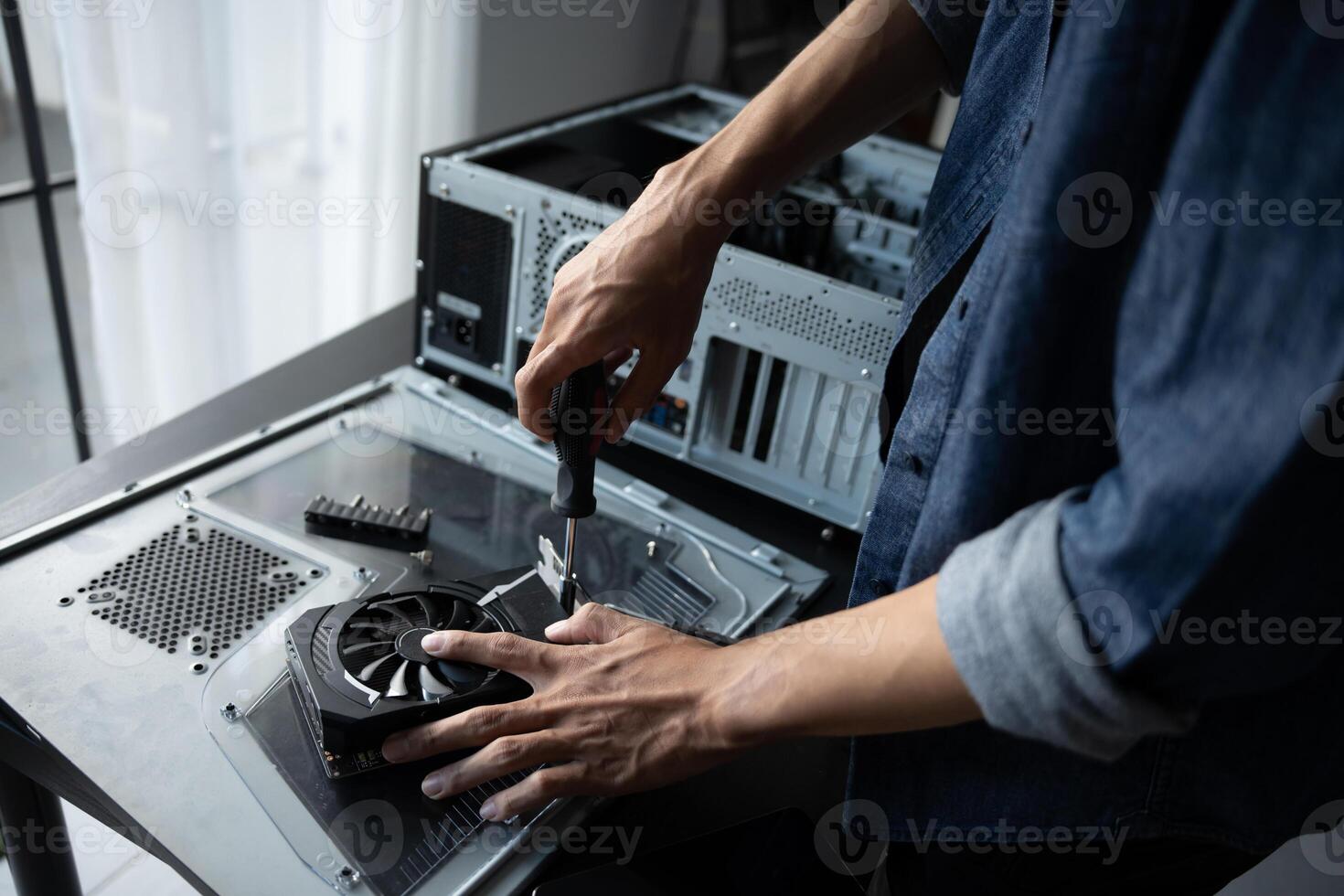 a Engineer installing Hardware fixing a computer case photo