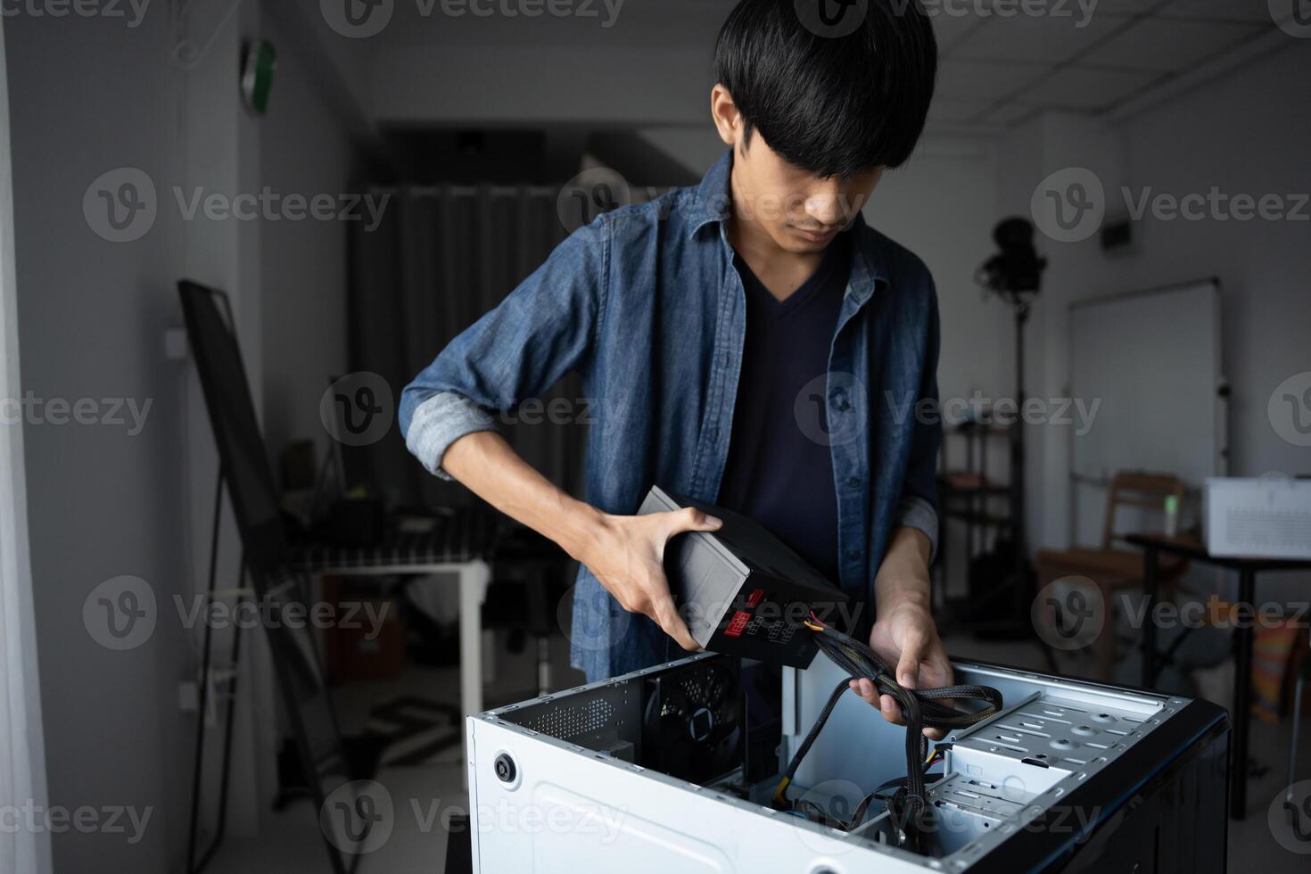 a Engineer installing Hardware fixing a computer in a room photo