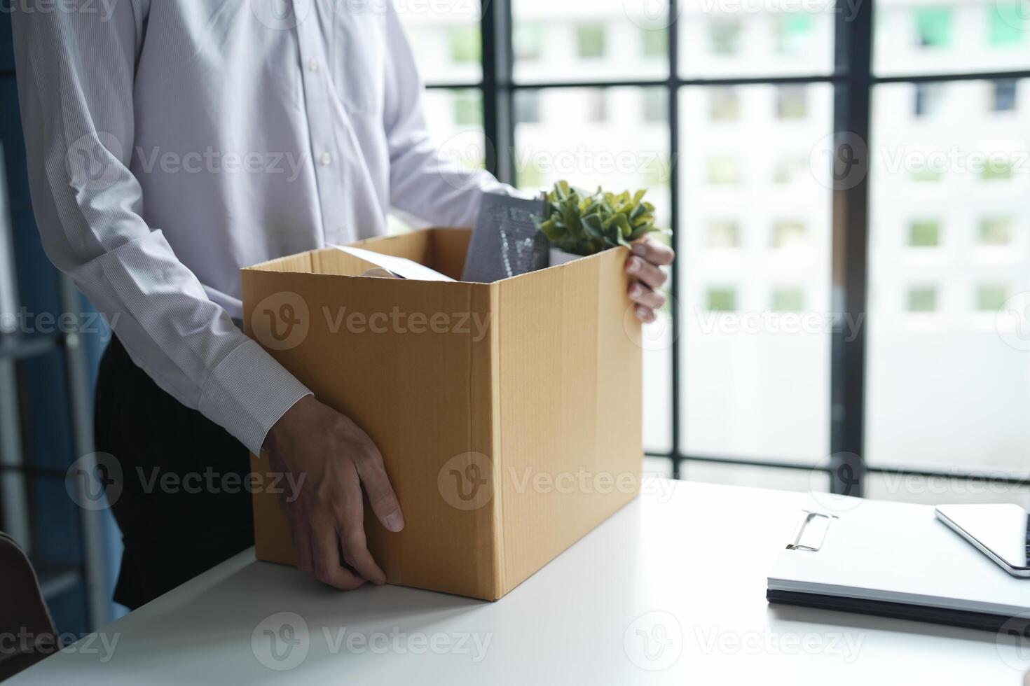 Business man carrying business cardboard box Change of job or fired from company resign. photo