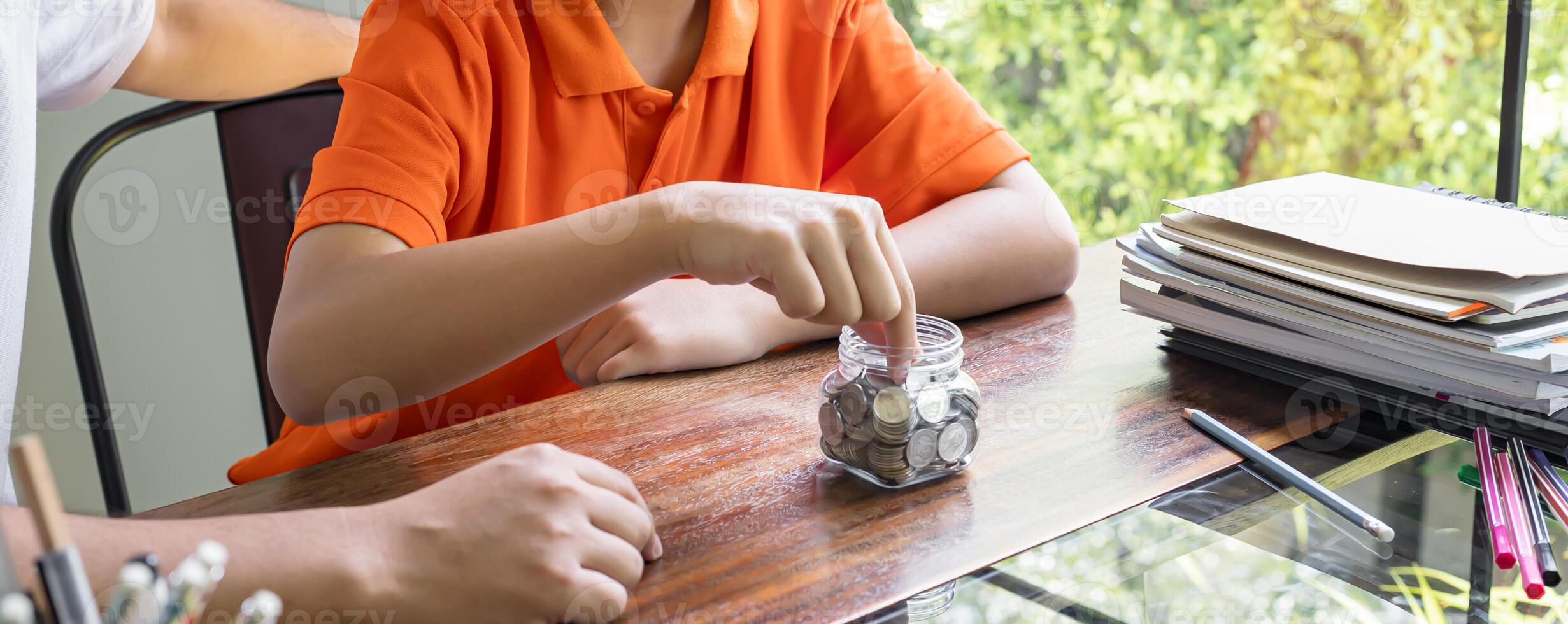 Asian father and son teaching son to Financial Literacy save money photo