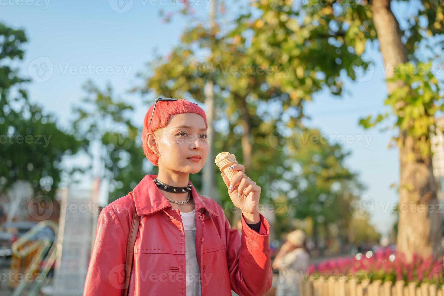 Traveler Gen z girl in a red jacket eating an ice cream photo