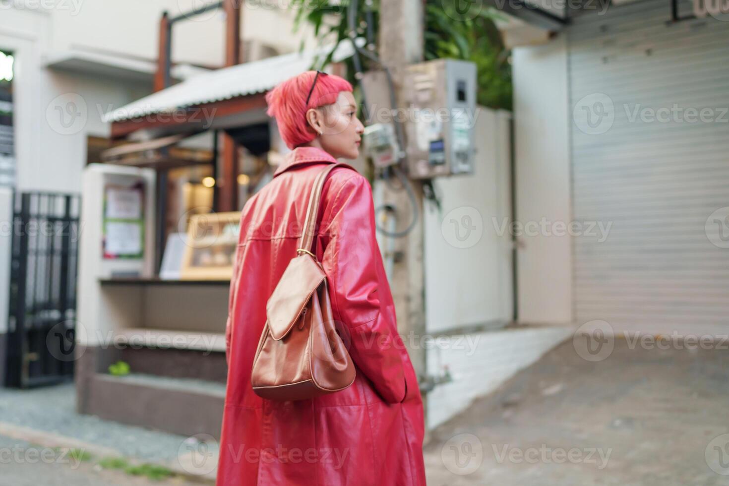 a Gen z girl with red hair and a red leather coat photo