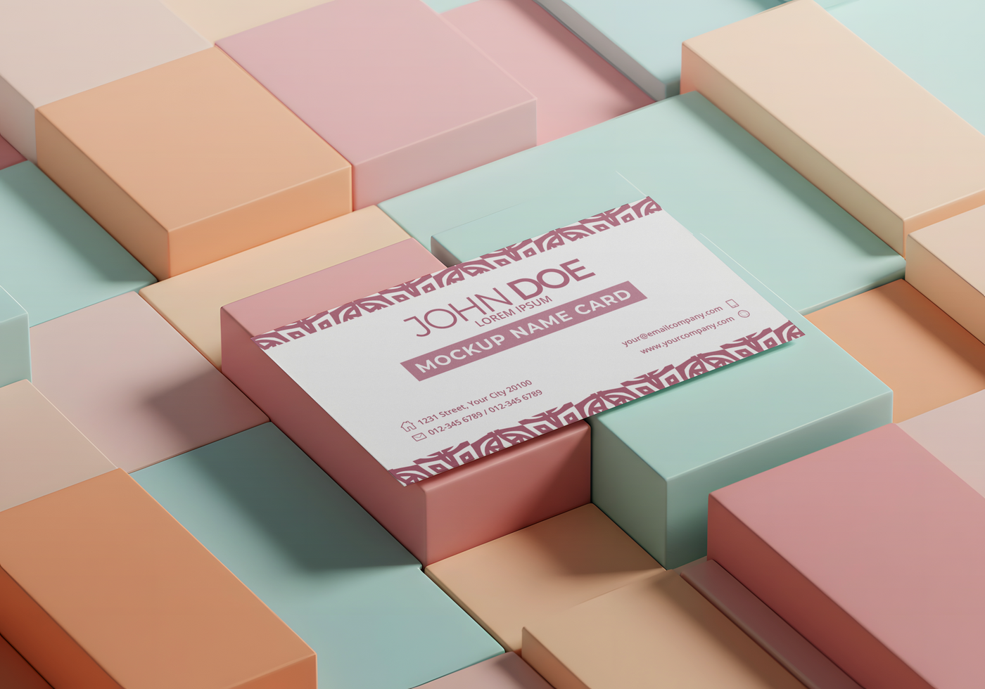 A mockup name card for John Doe rests on a pastel cube arrangement psd