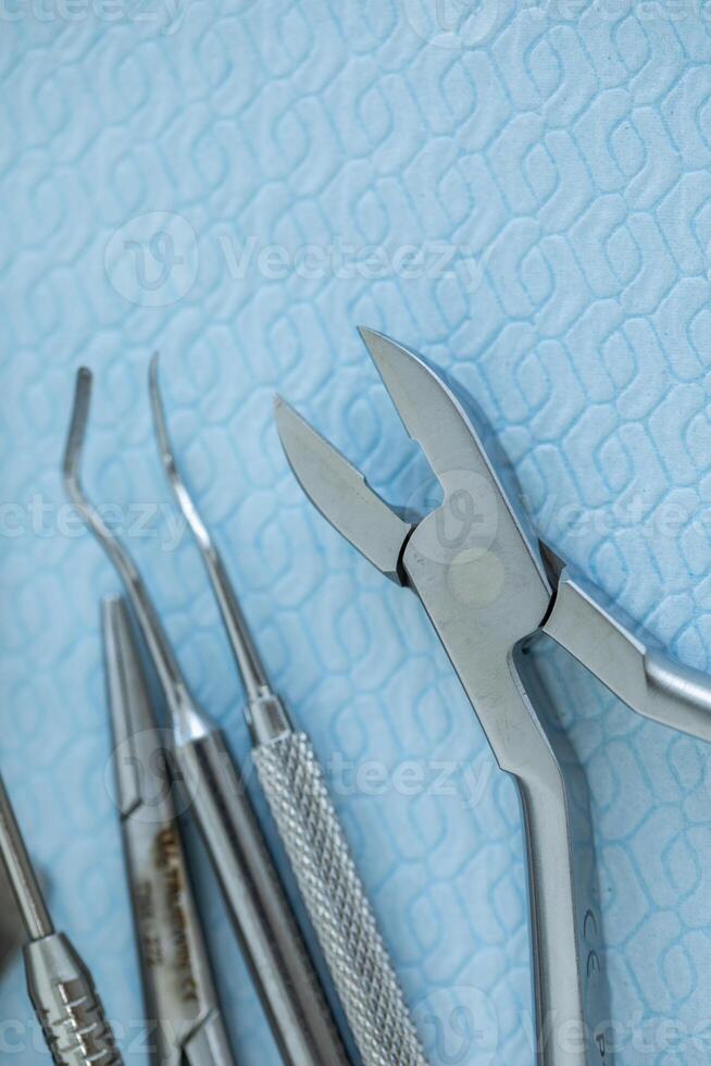 Dental tools and instruments on blue background, close-up. photo