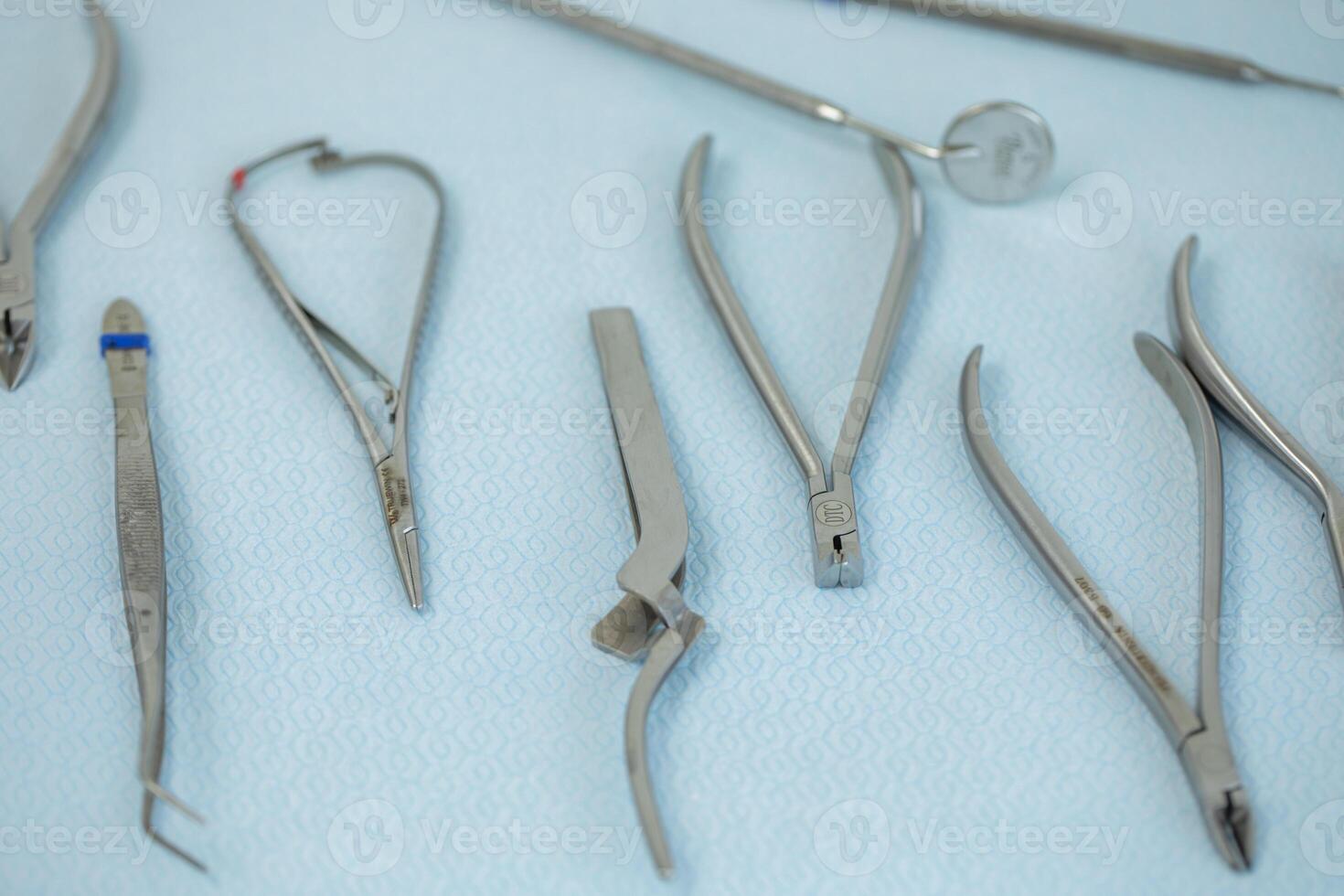 surgical instruments and tools for operation on a blue background closeup photo