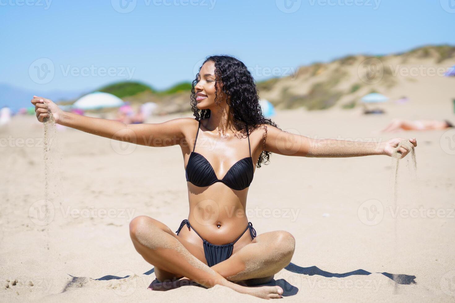 A Joyful Beach Moment A Woman Passionately Enjoying a Wonderful Day Under the Sun photo