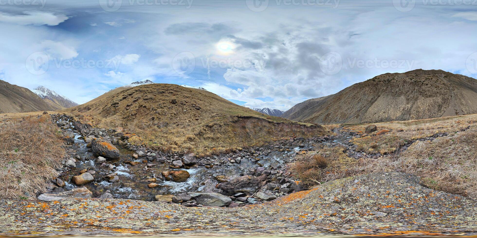 A 360 by 180 degrees equirectangular panorama Mountain Valley Riverbed with rocky river in Kyrgyzstan at spring day. photo