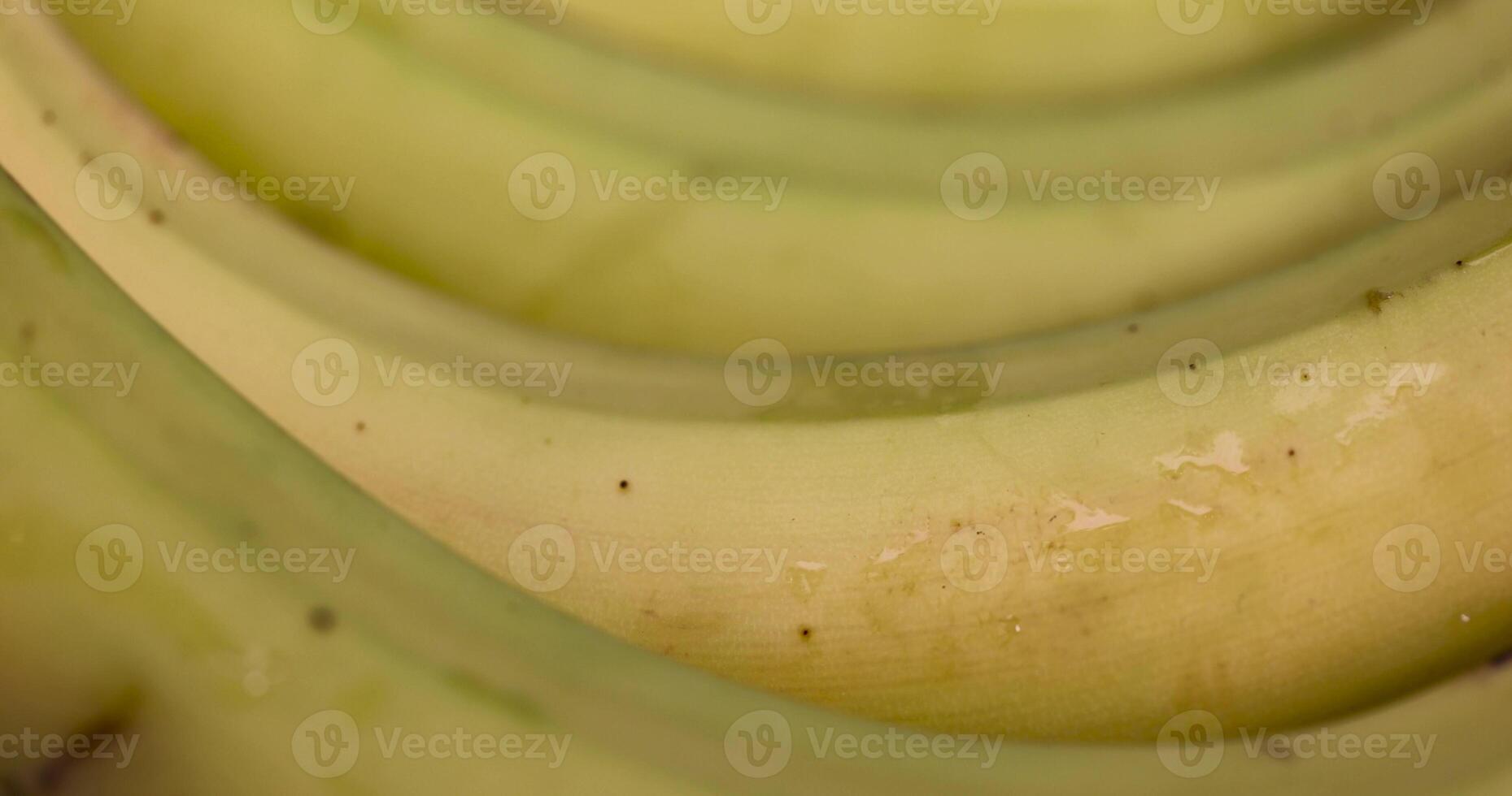 a ripe banana with a yellow-green peel is on the table photo