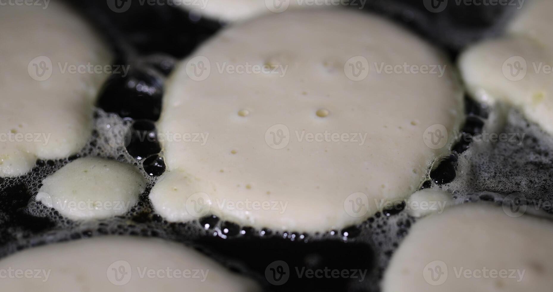 pancakes in a frying pan closeup, metal pan while cooking pancakes with butter photo