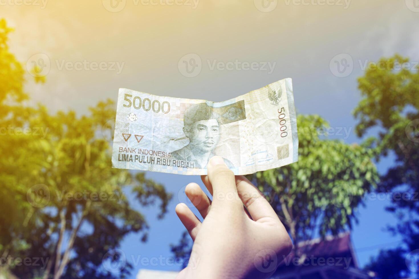 money from Indonesia is held by women photo