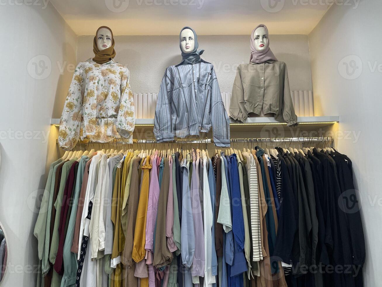 Stylish Hijab Fashion Display with Mannequins and Pastel Modest Outfits in Boutique Setting photo