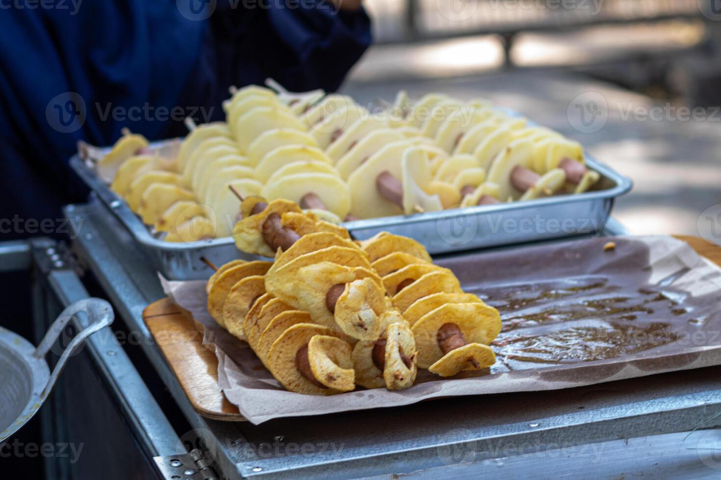 A person is holding a tray of food photo
