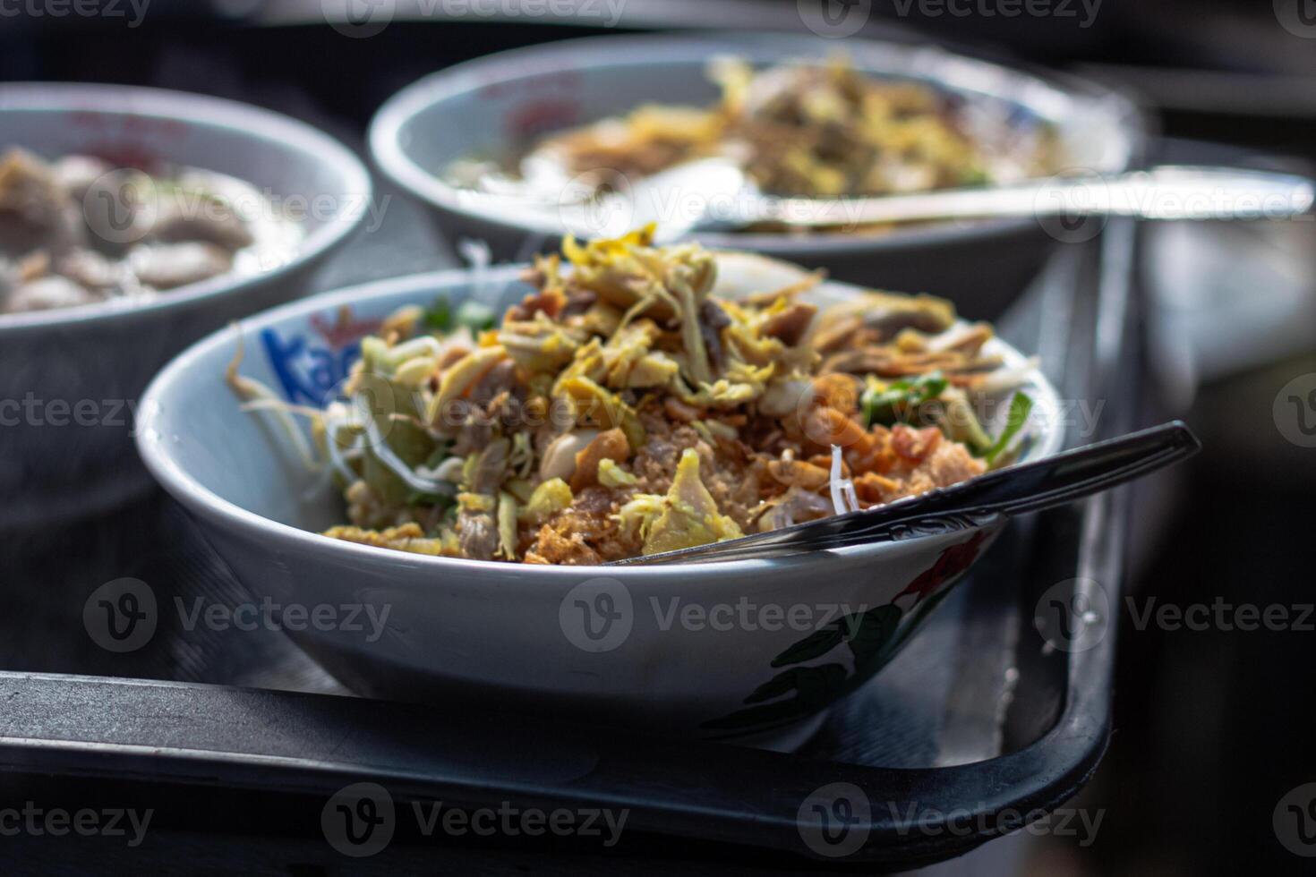 A tray with three bowls of food photo