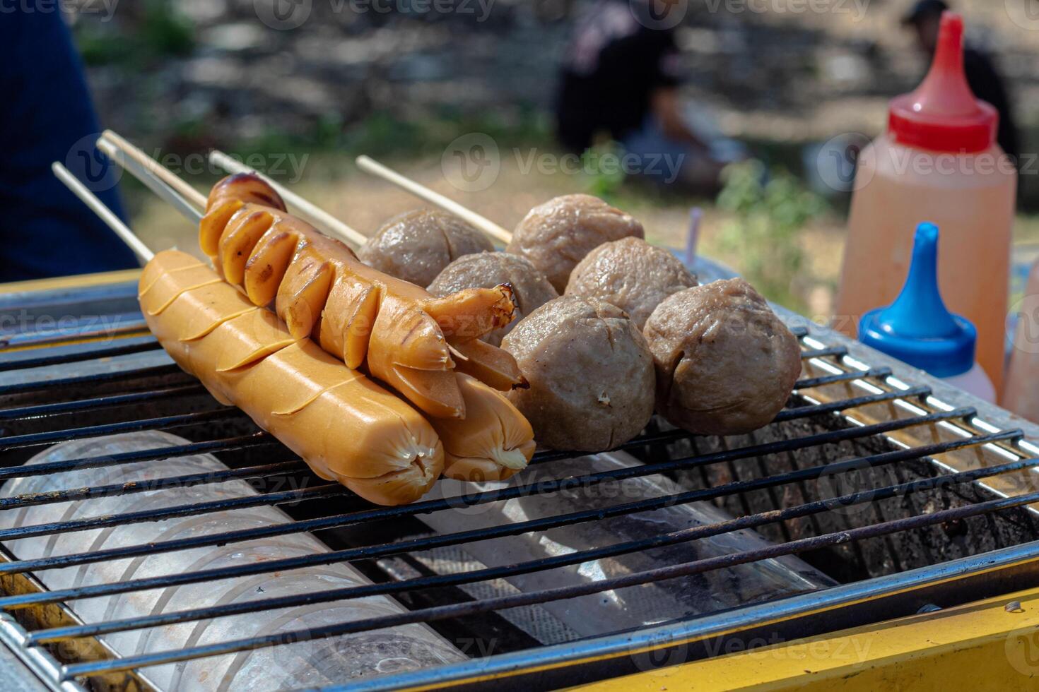 A grill with hot dogs and sausages on it photo