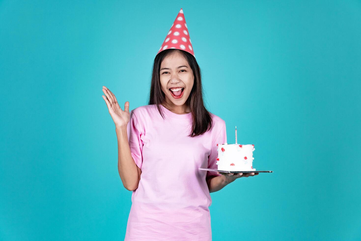Portrait of Cheerful Young Asian Woman Celebrating Birthday And Surprise Background photo