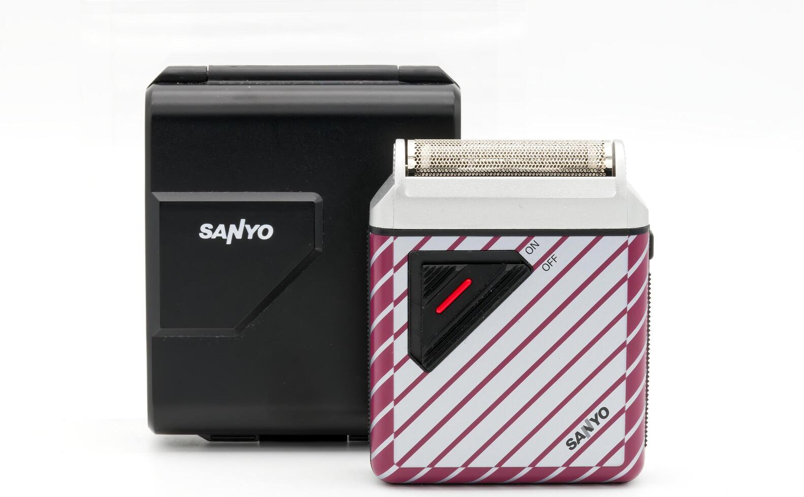 Bologna Italy June 20, 2025 Vintage Sanyo SV-M735 battery shaver, and it's black case. Studio shot. photo