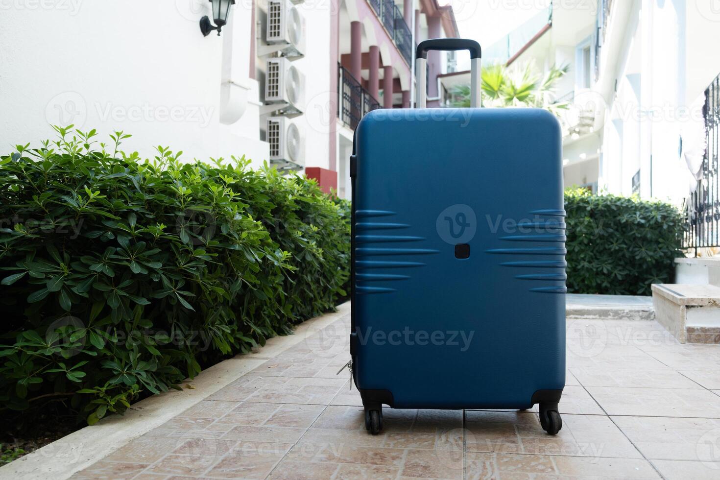 Travel suitcase outdoors. Tourism and summer vacation concept. photo