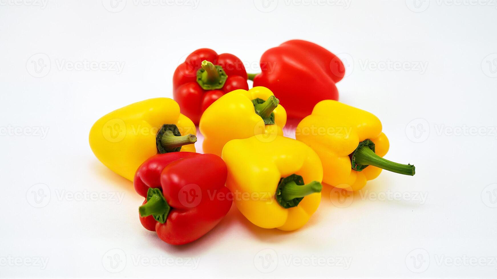 Yellow and red mini bell peppers isolated on a white background. Suitable for food, nutrition, and healthy eating concepts. photo