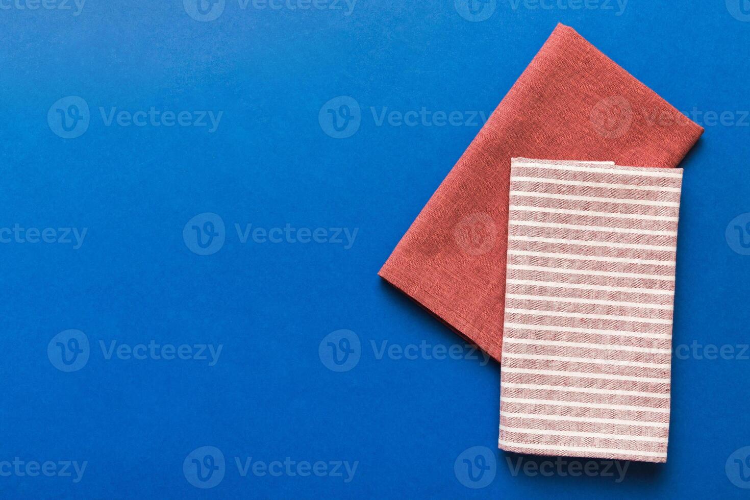 top view with red empty kitchen napkin isolated on table background. Folded cloth for mockupce photo