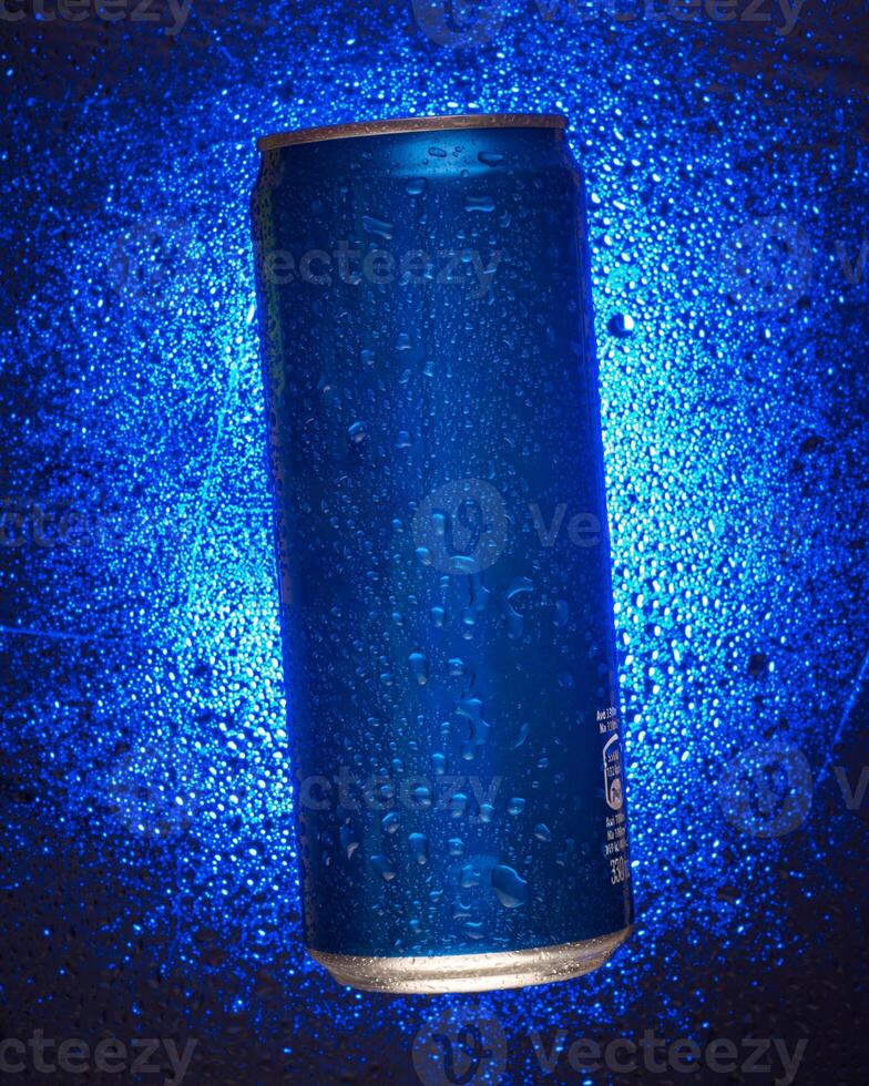 Blue can on a glass background with water drops photo