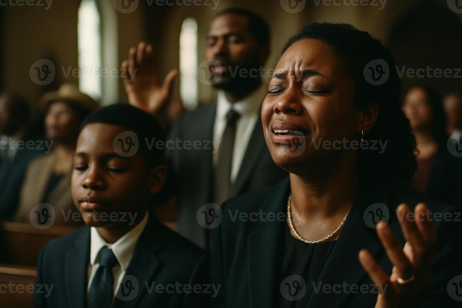 Emotional black woman crying and worshipping in a church service photo