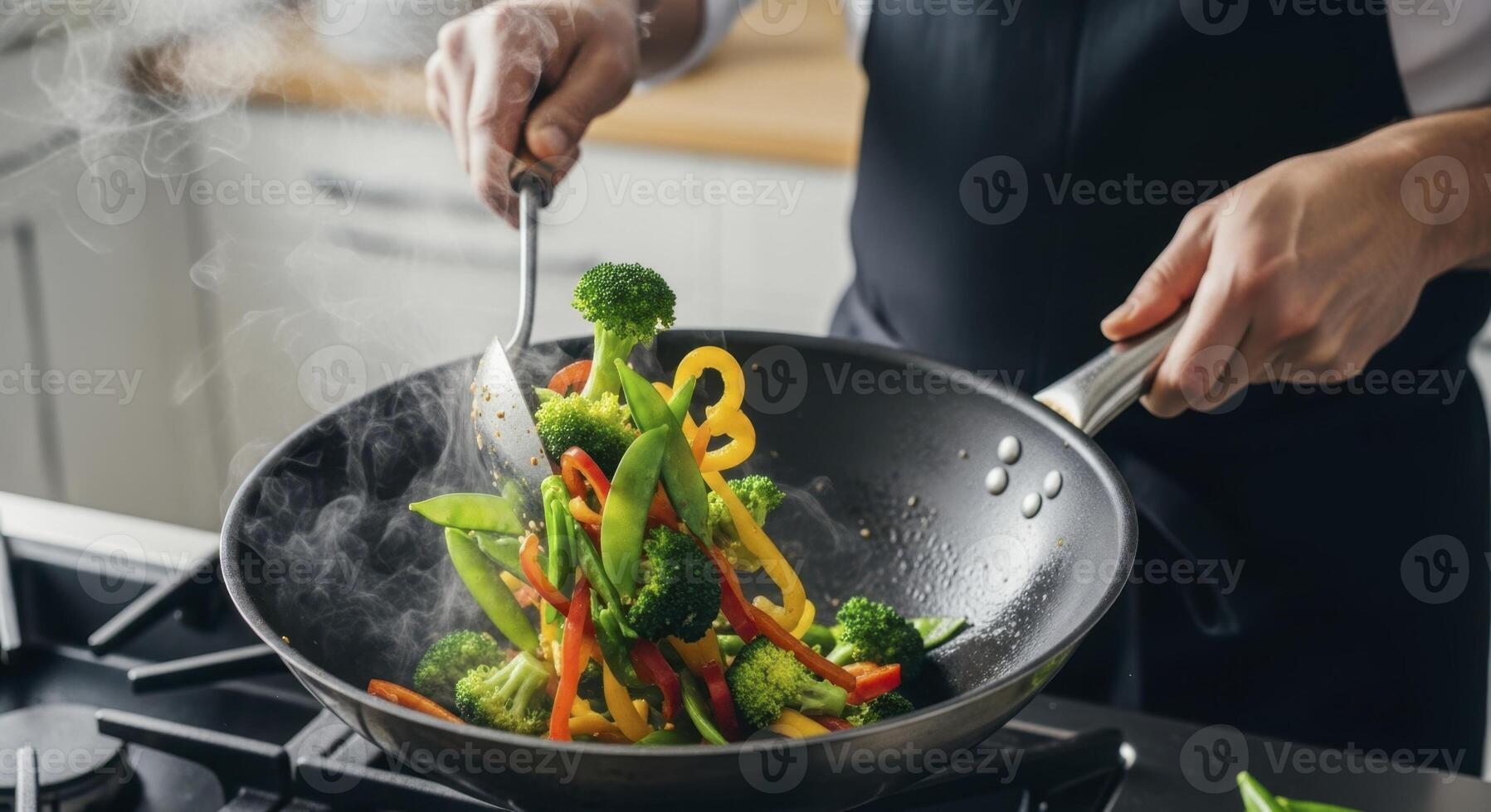 Chef hands stir frying vibrant vegetables in a wok with rising steam photo