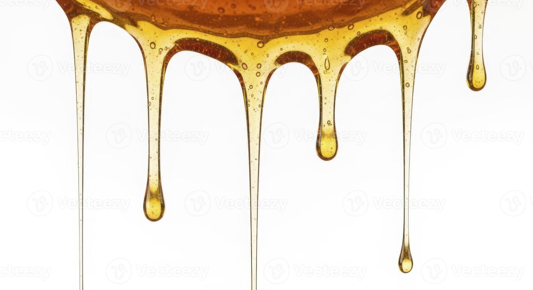 Thick golden honey dripping down against a pure white background photo