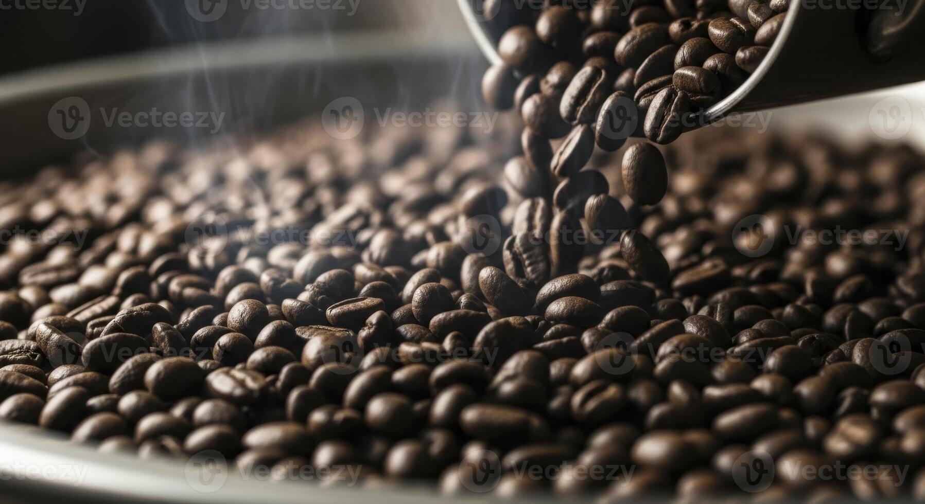 Freshly roasted coffee beans cascading into a cooling tray with visible steam photo