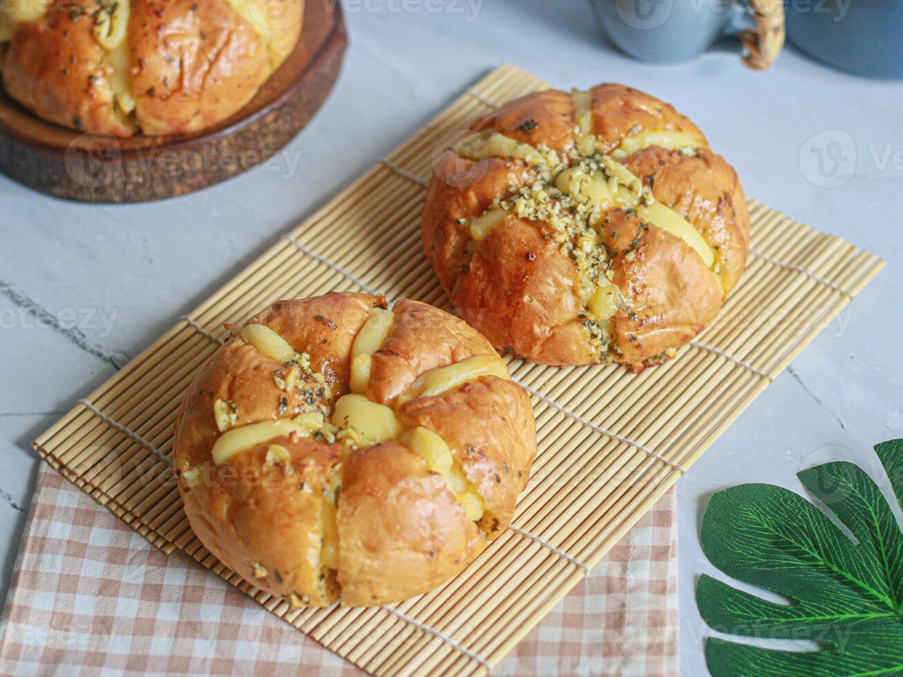 Three buns on a bamboo mat with a tea cup photo