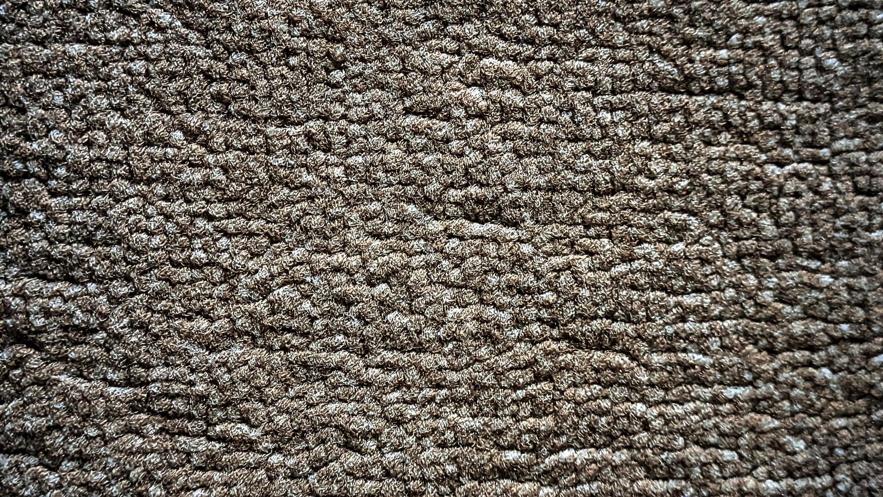 A close up of a carpet with a brown color photo