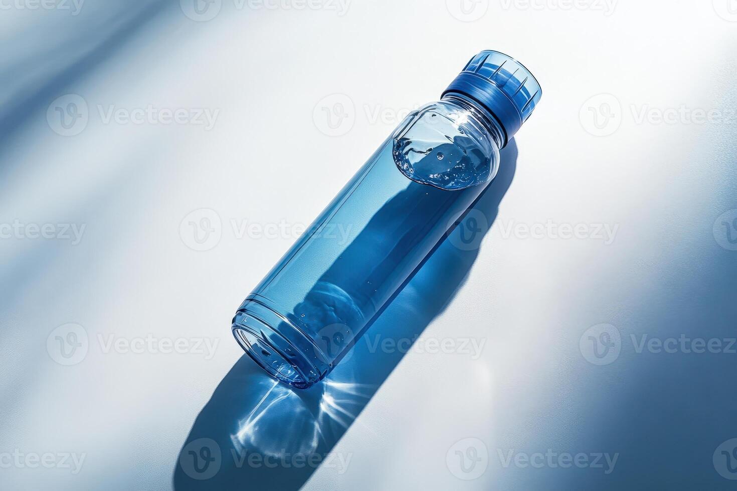 A blue water bottle on a white surface photo