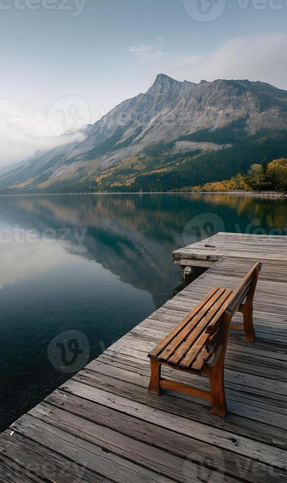 Idyllic mountain landscape with tranquil lake reflection and wooden pier bench for contemplation photo