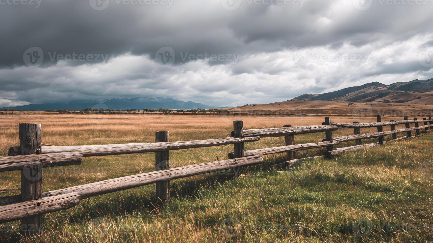 Dramatic cloudy sky over vast Montana field with wooden fence landscape under overcast sky photo