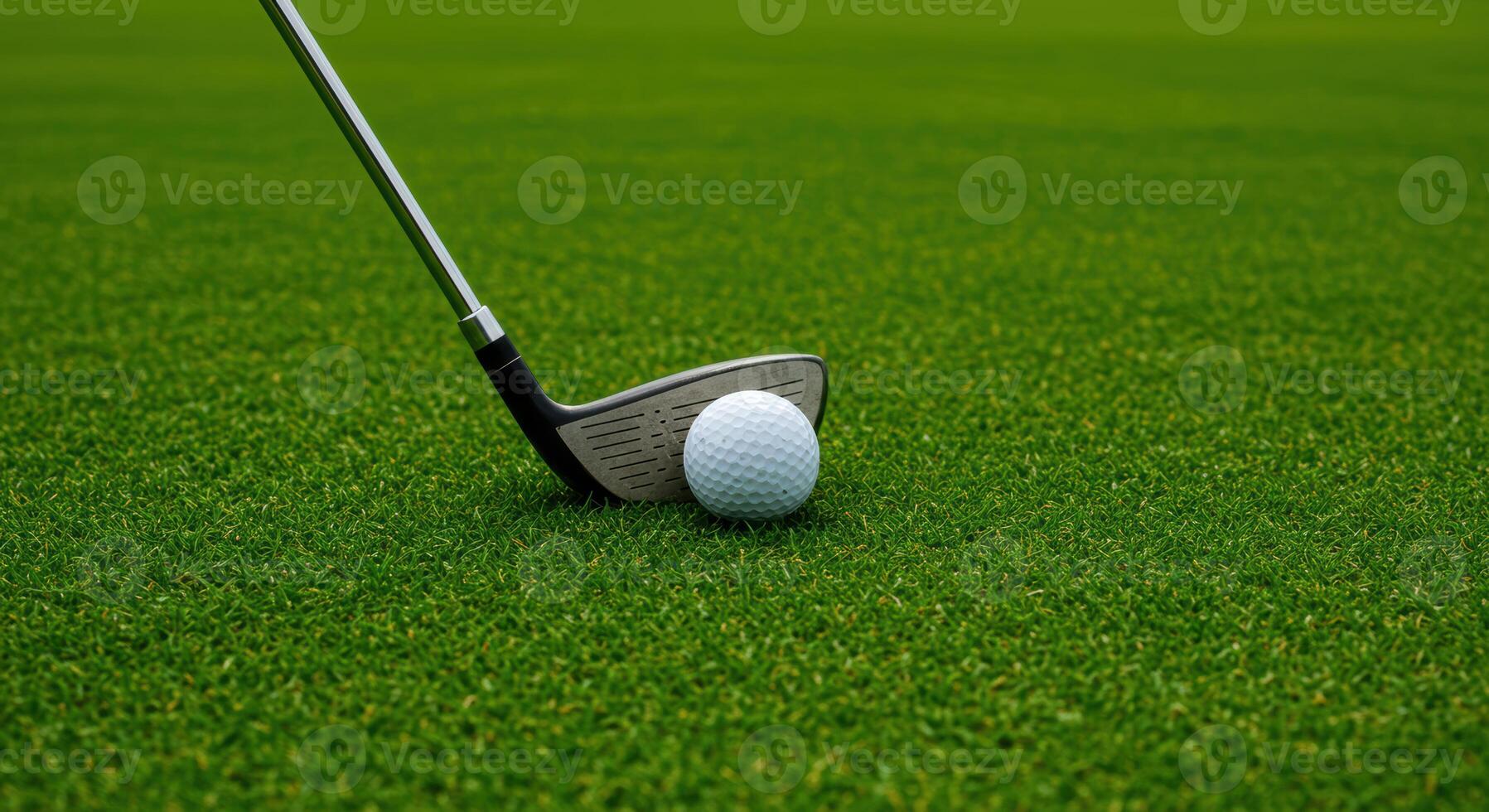Golf ball and club resting on lush green grass ready for a swing on a sunny day perfect for sports and recreation themes photo