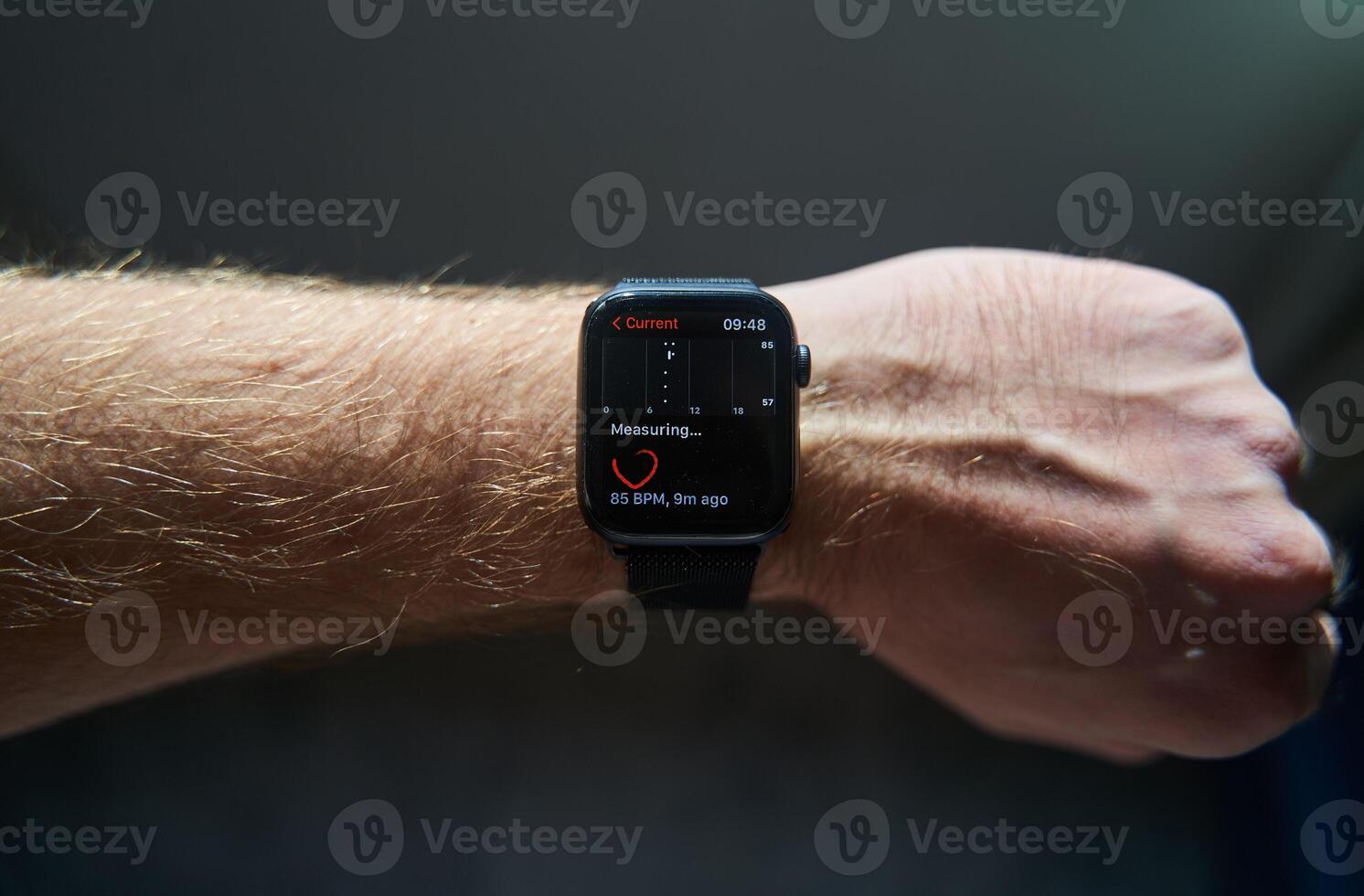A square smartwatch on a man's hand close up. Heart rate measurement on watch photo