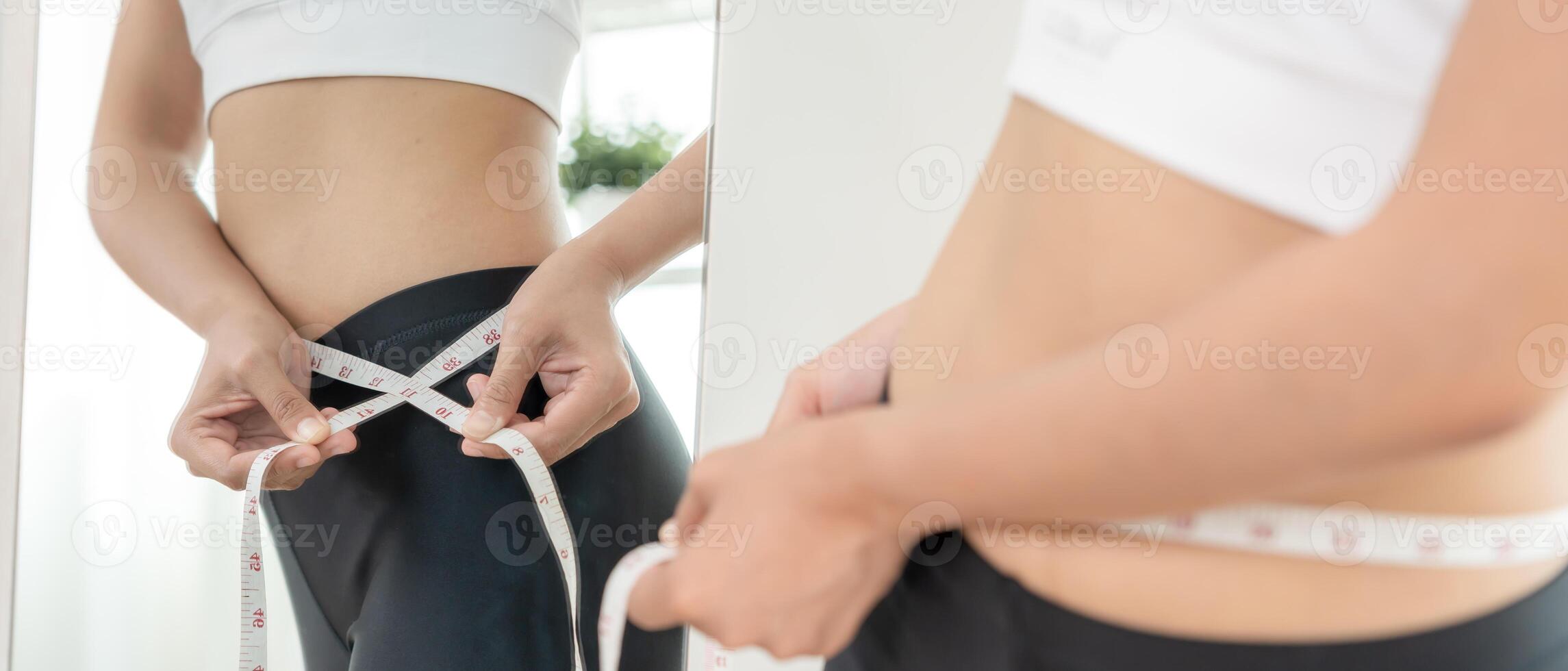 Women showing results of diet. Beautiful shape. female look mirror for check shape body have a reduced waist size after under going a weight loss corse. balance, control, routines photo