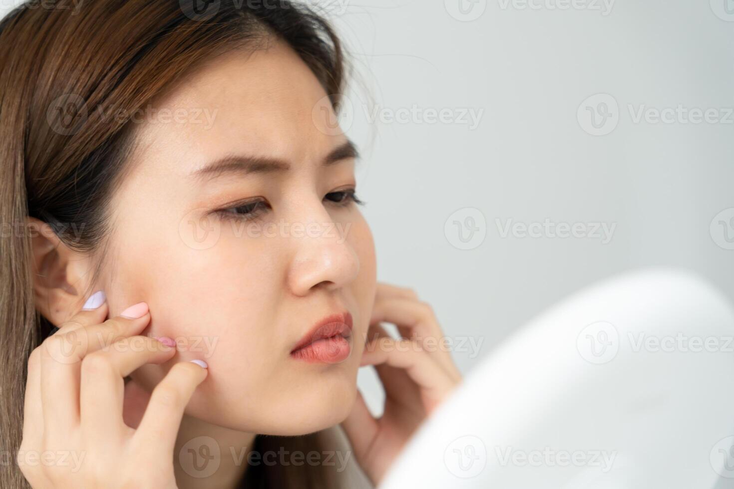 Young woman are worried about faces Dermatology and allergic to steroids in cosmetics. sensitive skin, red face from sunburn, acne, allergic to chemicals, rash on face. skin problems photo