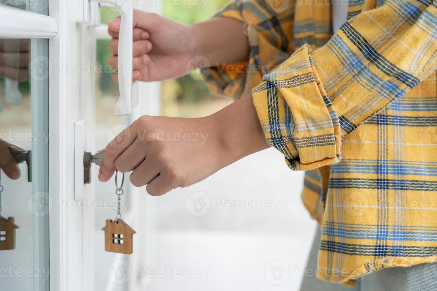 Landlord key for unlocking house is plugged into the door. Second hand house for rent and sale. Owner use hand unlock door mortgage for new home, buy, sell, renovate, investment, owner. photo