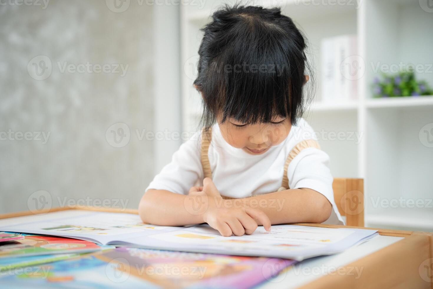 Happy Asian children relax read book at home. daughter and reading a story. learn development, childcare, laughing, education, storytelling, practice, imagine, reduce addiction mobile phone, photo