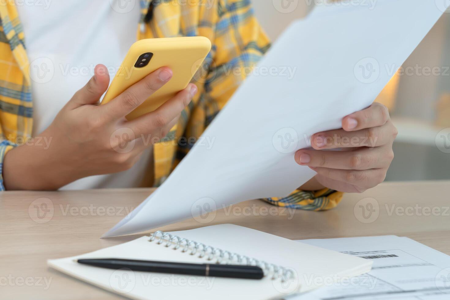 woman use phone scan barcode or QR codes to pay credit card bill after receiving document invoice. payment, receive, paying electricity, digital payments, technology, scanning, financial transaction. photo