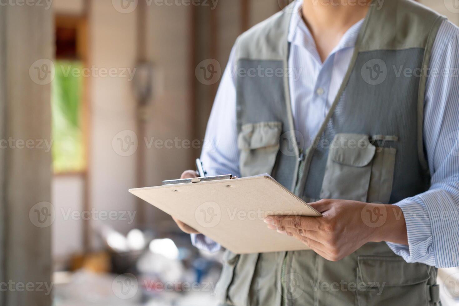 inspector or engineer is inspecting construction and quality assurance new house using a checklist. Engineers or architects or contactor work photo