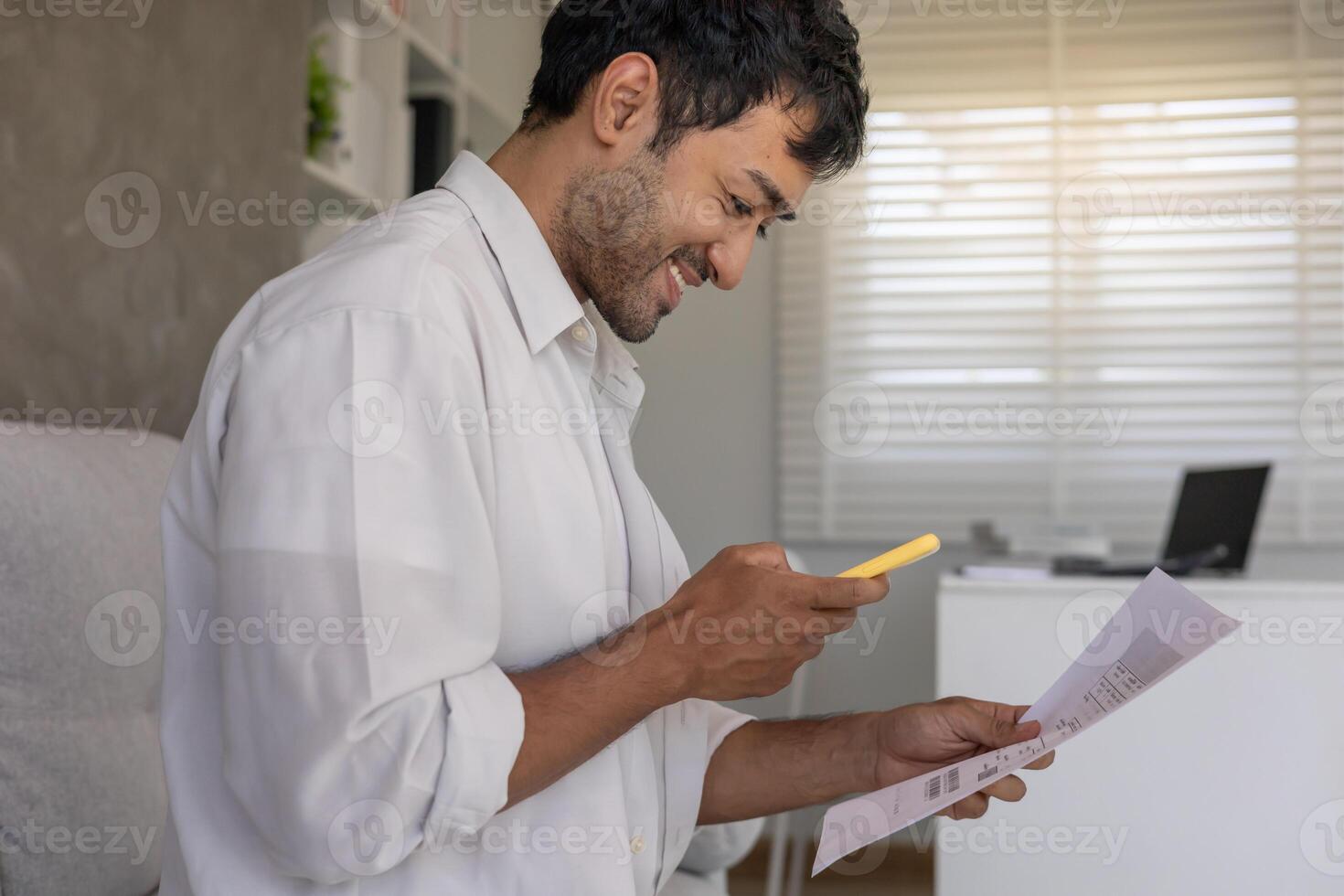 business man use phone to scan barcode or QR codes to pay credit card bill after receiving document invoice online. payment, receive, paying electricity, digital payments without money. photo