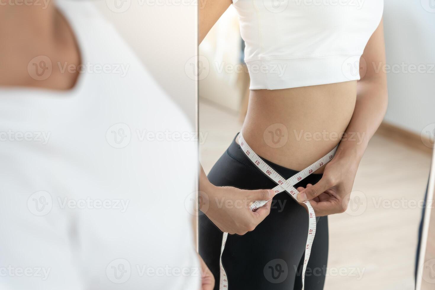 results of diet. Beautiful shape. female look mirror for check shape body have a reduced waist size after under going a weight loss corse. balance, control, routines, exercise. photo