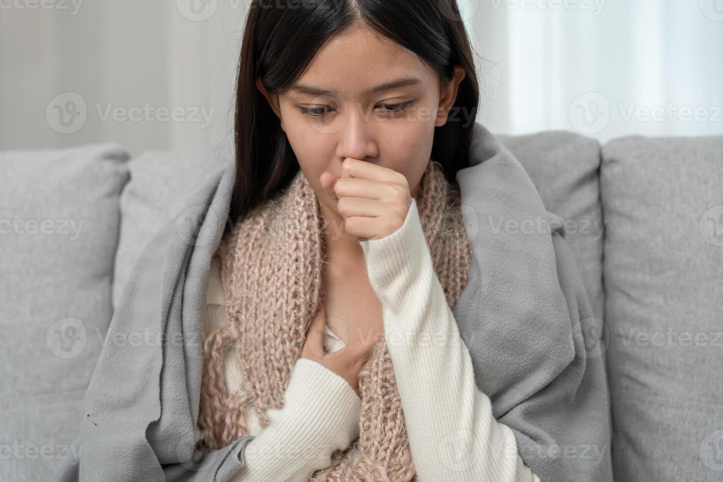 sick woman with a headache sitting under blanket, female sneezing and runny nose with seasonal influenza, allergic, high fever and influenza, resting, virus, coronavirus, feel illness photo