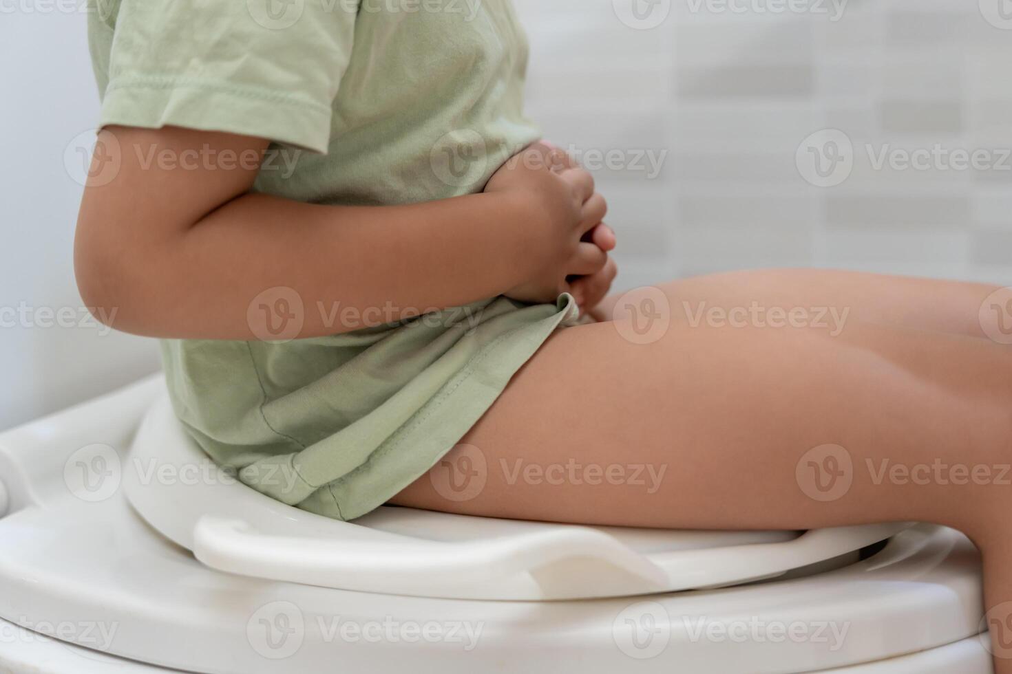 child in the toilet, constipation in children, dyspepsia, abdominal pain, crying, defecating, straining, urinary incontinence, blood in the stool, bowel problems, ulcerative colitis, diarrhea photo