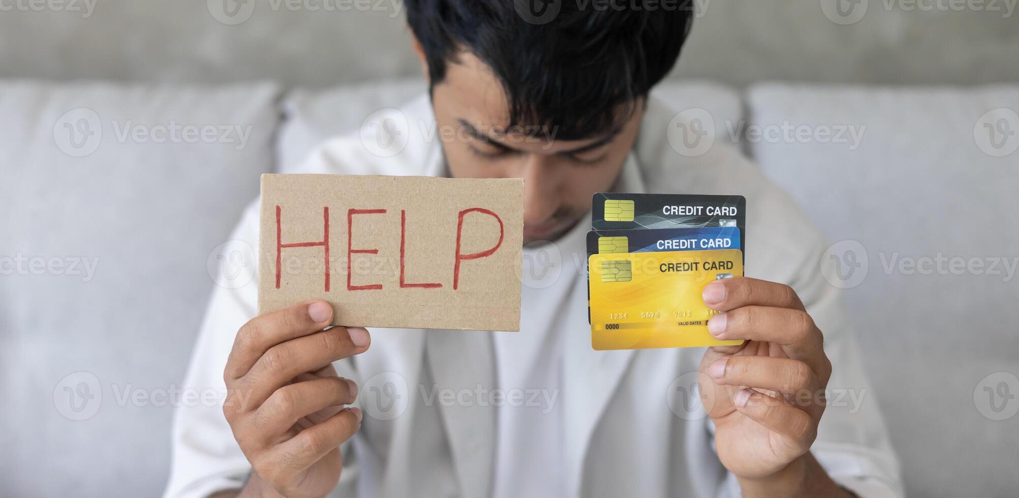 Stressed and headache asian man with large bills or invoices no money to pay to expenses and credit card debt. shortage, Financial problems, mortgage, loan, bankruptcy, bankrupt, poor. empty wallet. photo