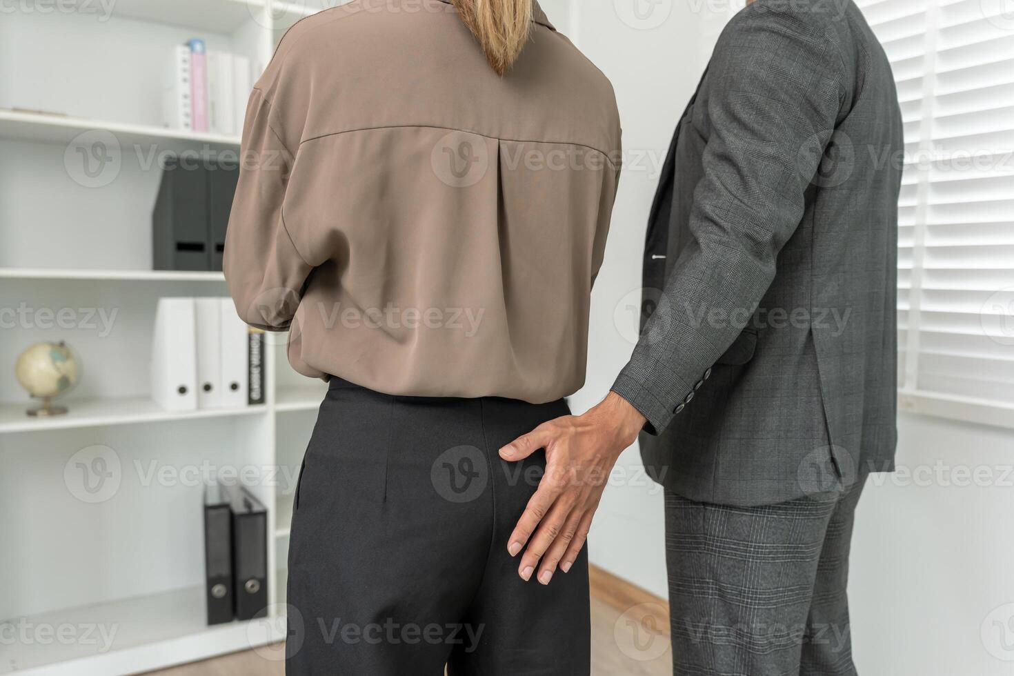 Manager or senior sexually harassed a female colleague by touch her bottom. Sexual harassment in office. feel anxious and stressed from being harassed. molest, assault, inappropriate. photo