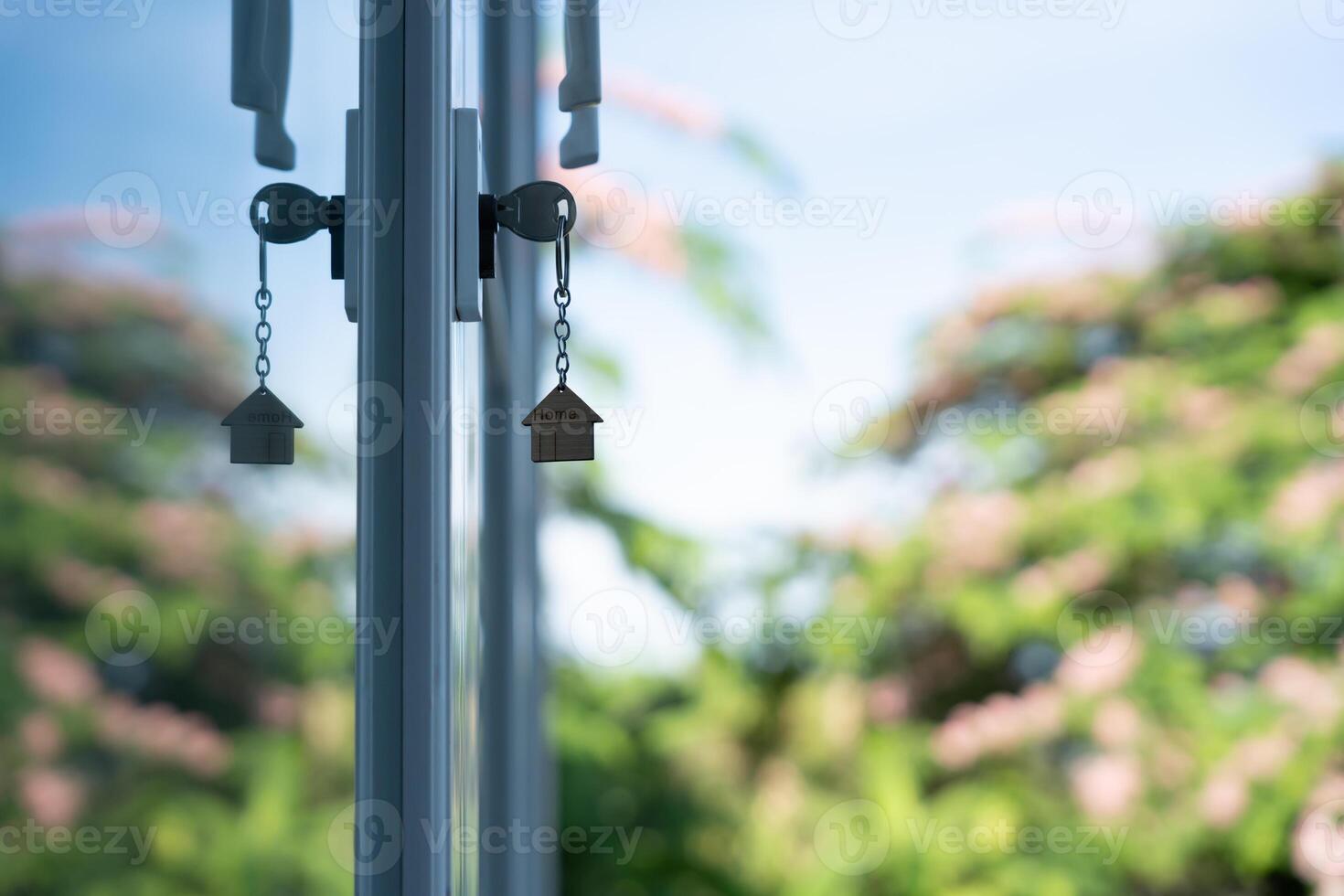 key for unlocking house is plugged into the door. Second hand house for rent and sale. keychain is blowing in the wind. mortgage for new home, buy, sell, renovate, investment, owner. photo
